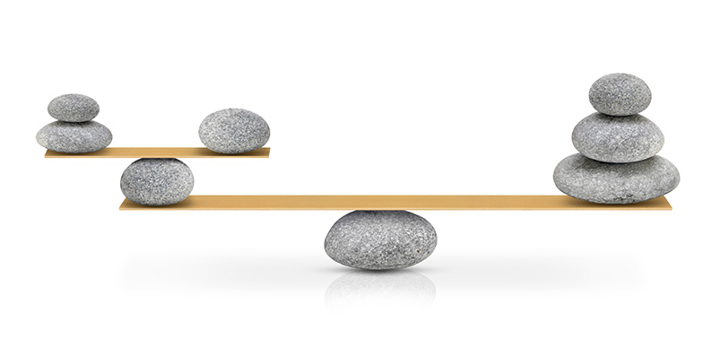 round stones balanced on slender boards